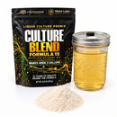 A black stand-up pouch of Myco Labs Culture Blend Formula 15 liquid culture premix stands next to a clear glass mason jar filled with golden liquid and a small pile of pale powder on a white background.