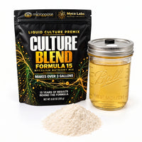 A black stand-up pouch of Myco Labs Culture Blend Formula 15 liquid culture premix stands next to a clear glass mason jar filled with golden liquid and a small pile of pale powder on a white background.